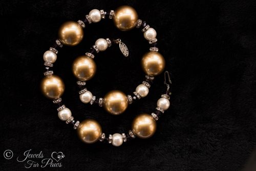 large gold pearl beads with small cultured pearls, purple swarovski crystals with channel set swarovski rhinestone spacers on white background