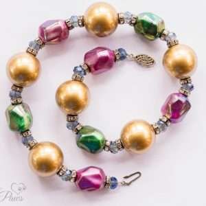 large gold pearl beads with iridescent green and fuchsia pink bauble beads clear swarovski crystal spacers channel set swarovski crystal rhinestone spacers on white background