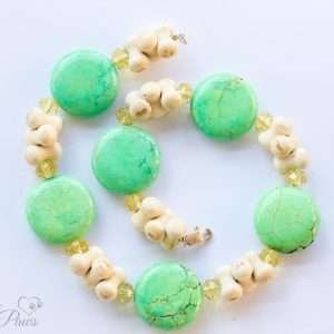 dog cat pet necklaces jewelry, clusters of stacked off-white bones with green turquoise discs and pale yellow swarovski crystals on white background