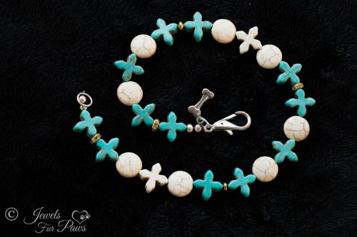 twelve blue turquoise blue crosses with white howlite crosses and white turquoise discs on black background