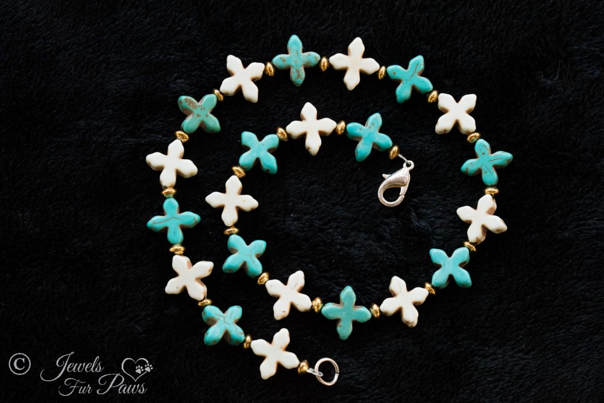 dog cat pet necklaces jewelry pale blue turquoise crosses with white howlite crosses and gold spacers on a black background