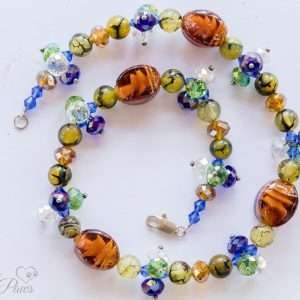 dog cat pet necklace with oval orange mahogany swirled lampwork beads and multi colored brown crystal beads on white background