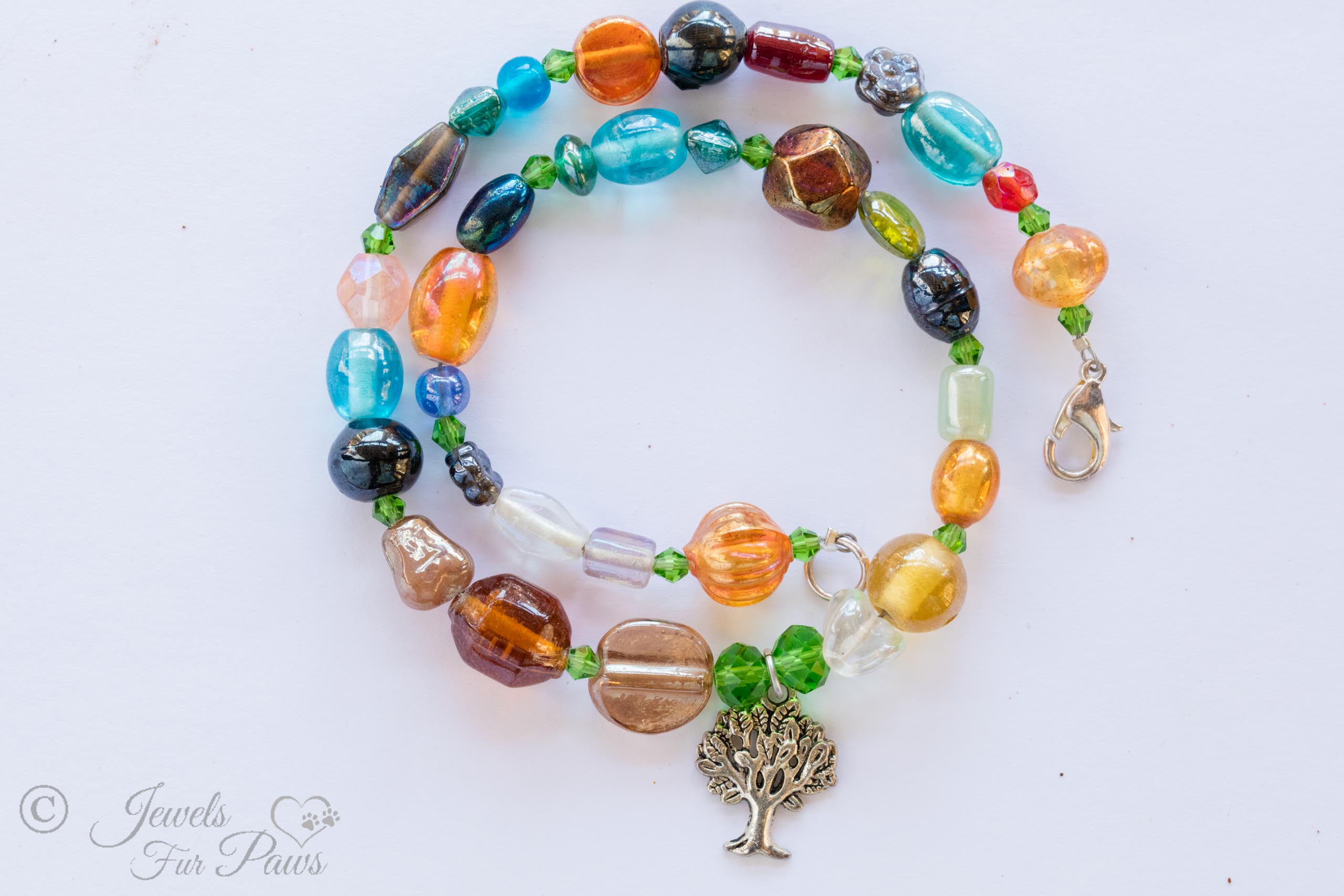 dog cat pet necklace tree of life charm multi colored irregular beads orange brown green blue red on white background