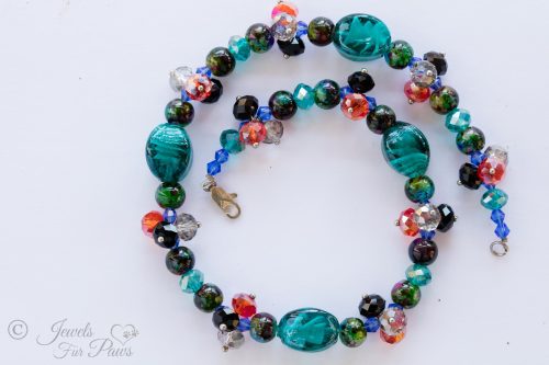 dog cat pet necklace with oval blue lampwork glassbeads and multi colored marbleized beads with clusters of swarovski crystal beads on white background