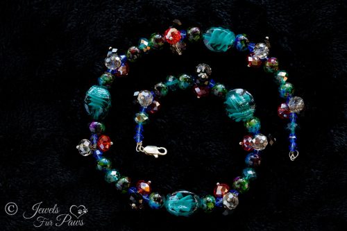 dog cat pet necklace with oval blue lampwork glassbeads and multi colored marbleized beads with clusters of swarovski crystal beads on black background