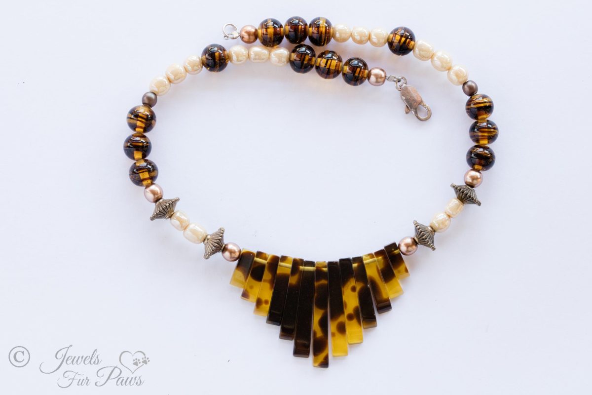 vintage Japanese cultured pearls with tigers eye tortoise shell beads and tortoise shell "piano" graduated flat beads on black background