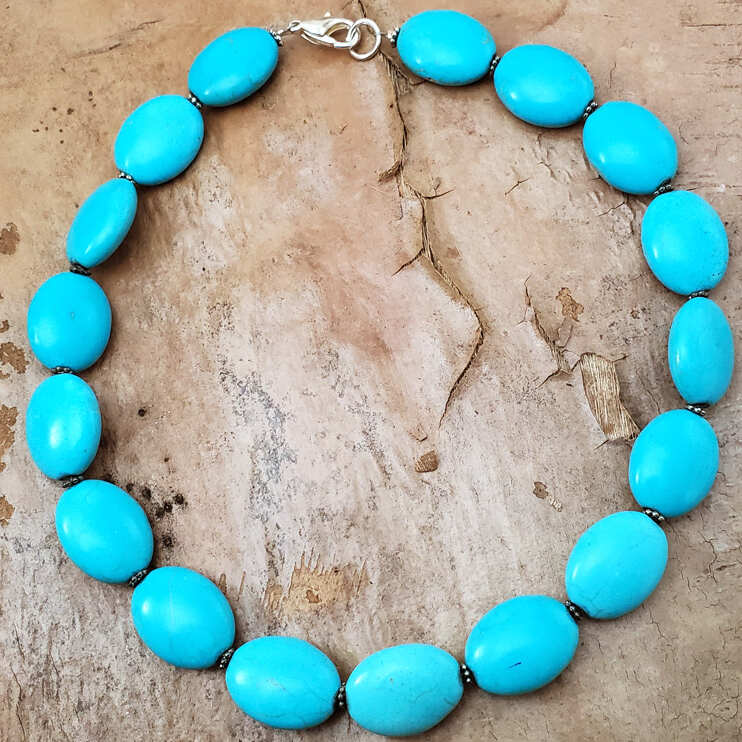 flat oval bright turquoise beads with silver spacers