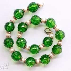 round green acrylic faceted beads strung with cultured pearls and channel set Swarovski crystal spacers on white background