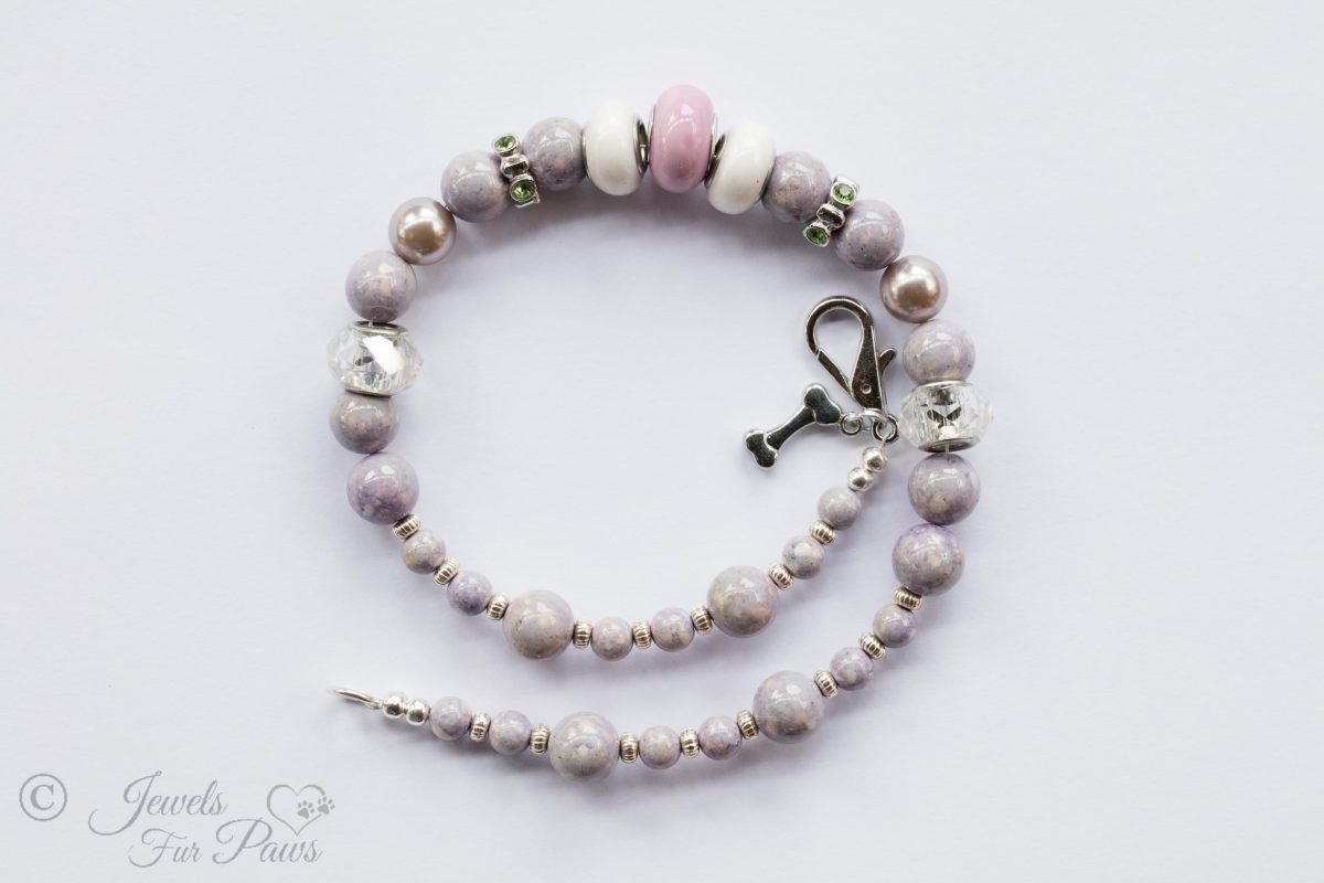pale lavender round beads with silver rhondell spacers and faceted crystals on white background