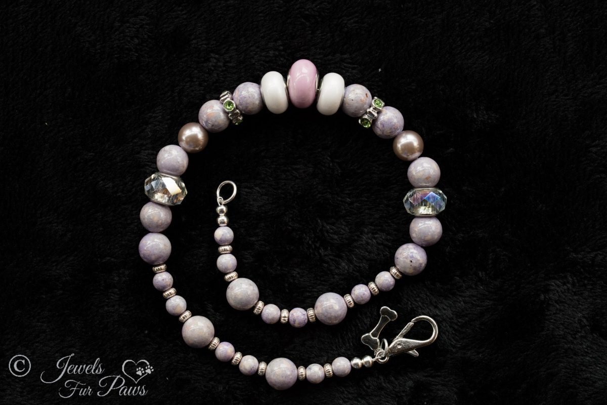 pale lavender round beads with silver rhondell spacers and faceted crystals on black background