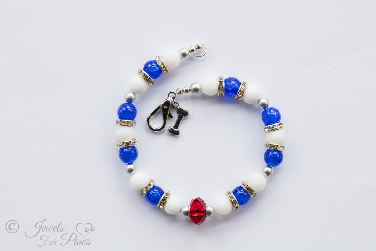 patriot red white and blue beaded necklaces blue and white beads strung with crystal channel set spacers and a large red Czech crystal on a white background