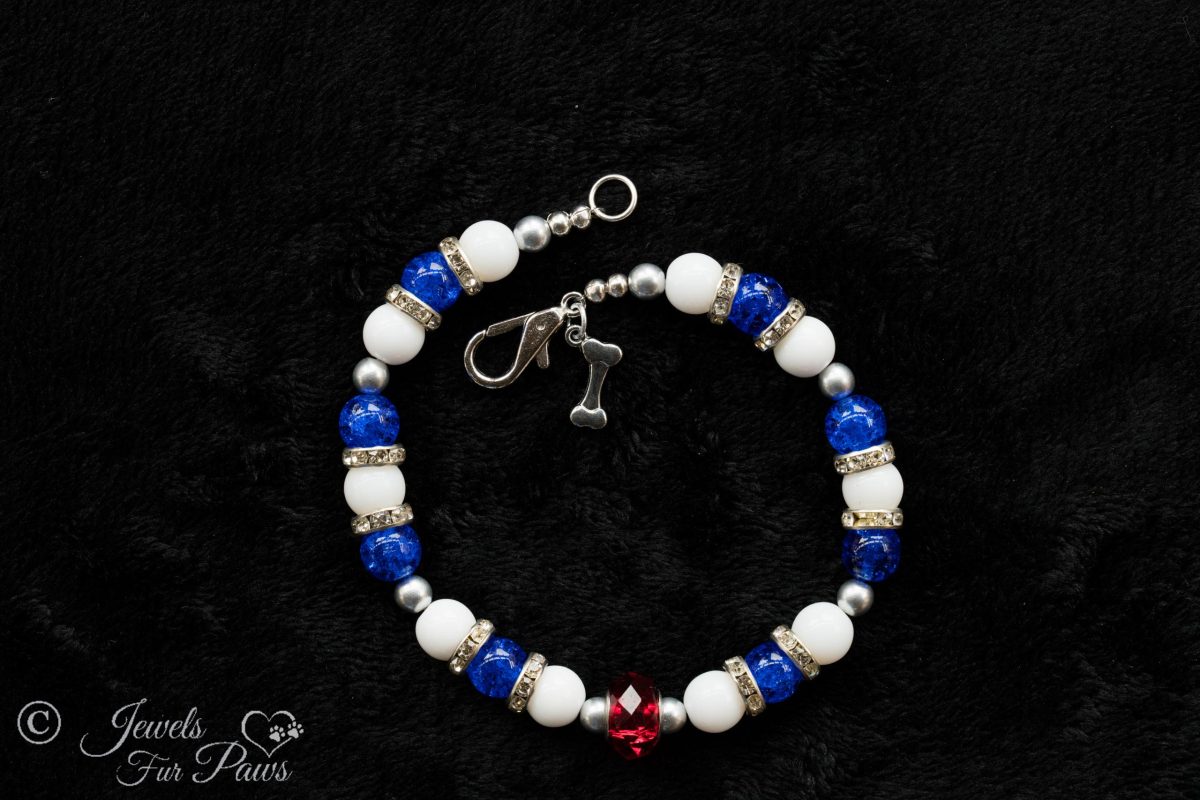 patriot red white and blue beaded necklaces blue and white beads strung with crystal channel set spacers and a large red Czech crystal on a black background