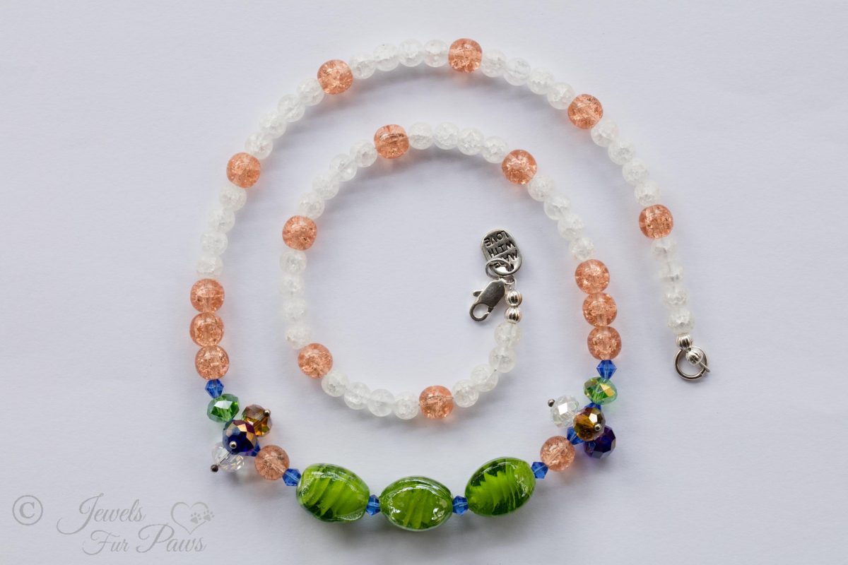 cat dog pet necklace three green lampwork beads with peach and white frosted glass beads on white background
