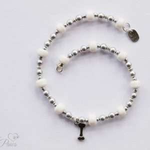 silver hanging bone charm strung with silver beads and larger white glass beads on a white background medium dogs pet necklace jewelry