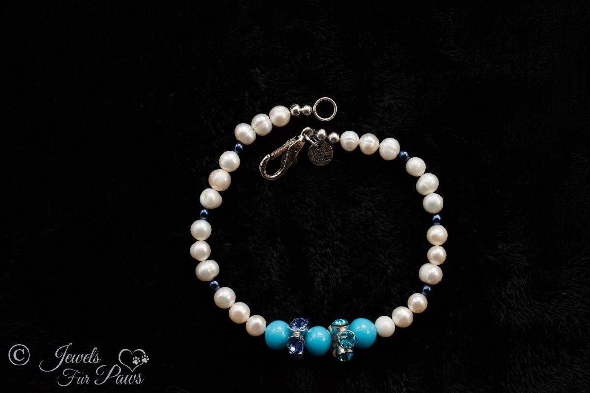 cultured pearls with small blue spacers and three turquoise beads with large swarovski crystal spacers on black background