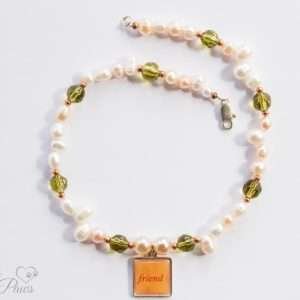 cultured pearls with green faceted Czech crystals and hanging square "friend" charm pendant on white background