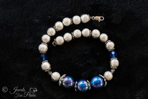 small cat dog pet necklace jewelry three large iridescent blue pearl beads with cultured pearls and silver hammered metal beads with blue swarovski crystal spacers on black background