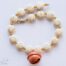 Sedona dark orange hanging bell necklace with white turquoise flat beads and amber faceted crystal spacers on white background