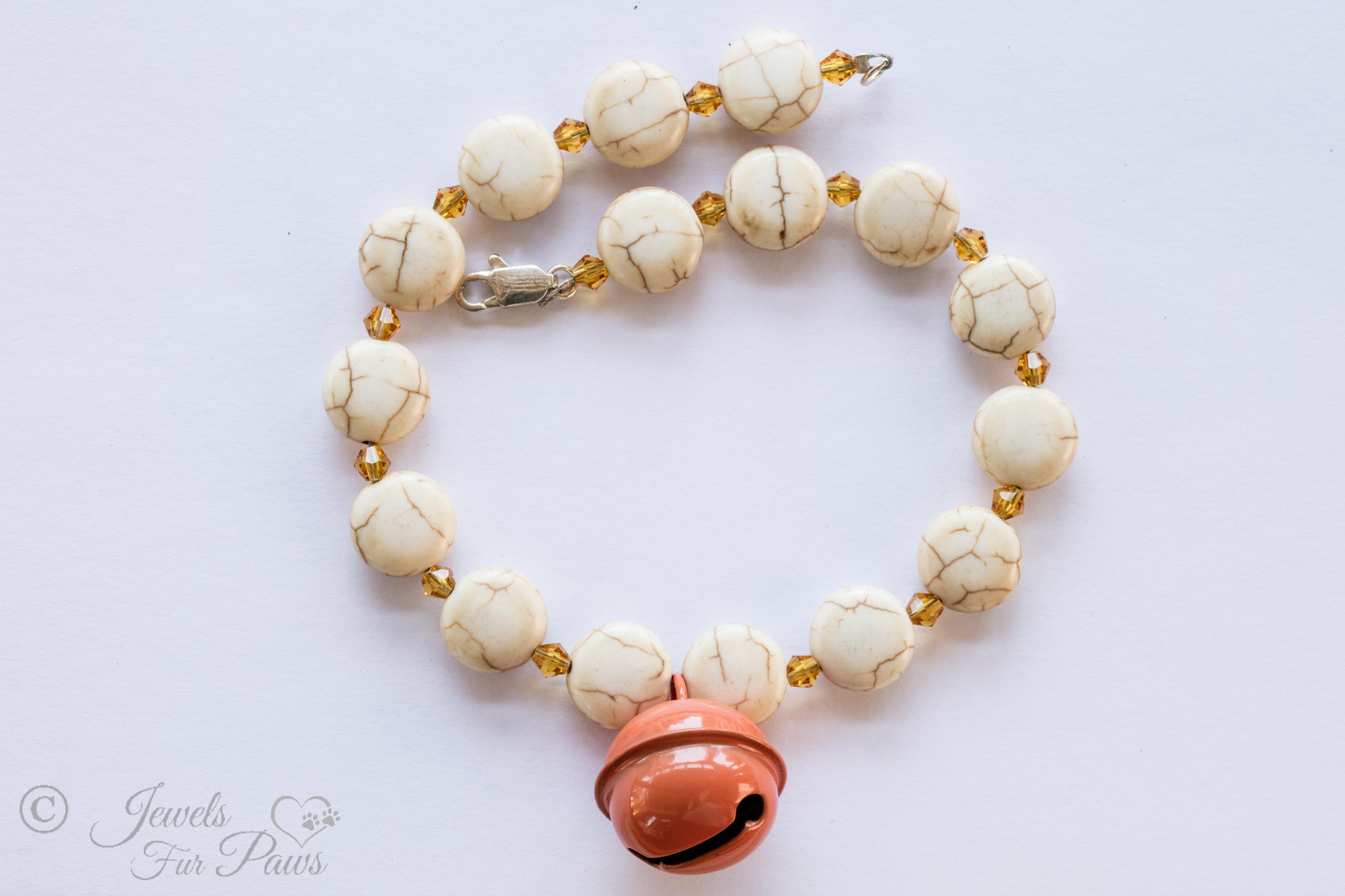Sedona dark orange hanging bell necklace with white turquoise flat beads and amber faceted crystal spacers on white background