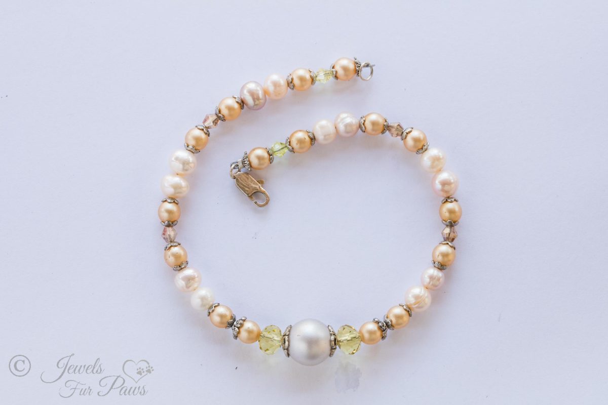 cultured pearl necklace with champagne pearls, large pearl, silver spacers for small dogs on white background