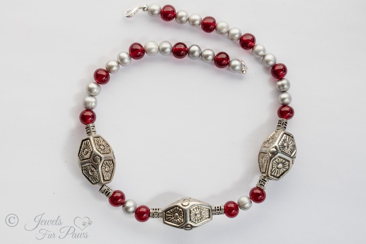 large dog cat pet necklace featureing three large silver indian style beads with freshwater pearls and red carnelians and filigree silver spacers on a white background