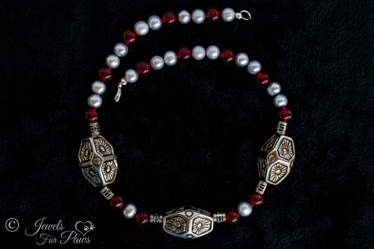 large dog cat pet necklace featureing three large silver indian style beads with freshwater pearls and red carnelians and filigree silver spacers on a black background