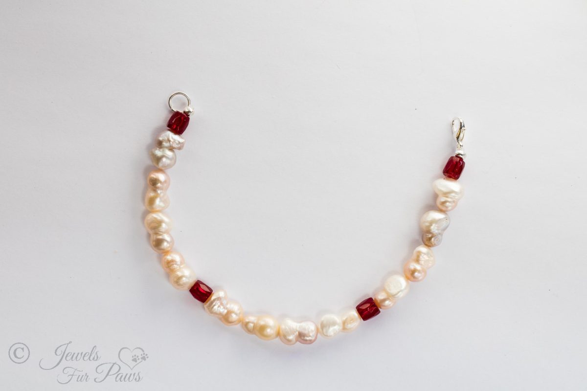 four red barrel garnets with freshwater pearls in a pet jewelry cat dog pet necklace on white background