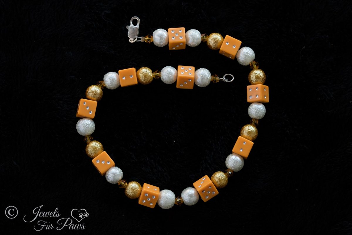 dog cat pet necklace with orange lucky dice, gold and silver brushed metal beads with orange swarovski crystal spacers on black background