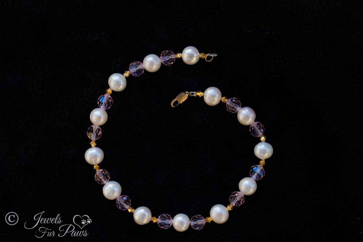 thirteen cultured pearls strung with pale pink Czech crystals and amber crystal spacers