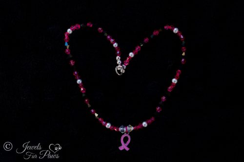 hanging breast cancer ribbon pendant charm on black background