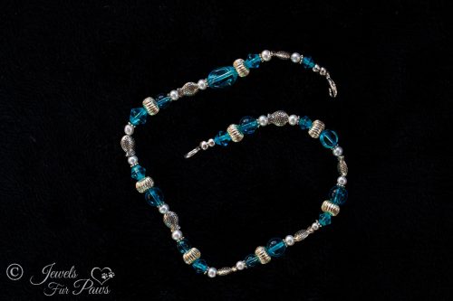 pet necklace with Silver rhondelles , silver fish spacers, and transparent robin blue beads on black background