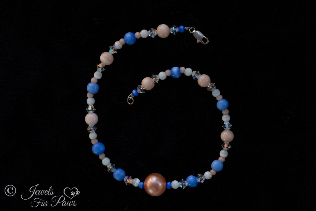 cat dog pet necklace large salmon orange bead with cats eye blue and white beads on black background