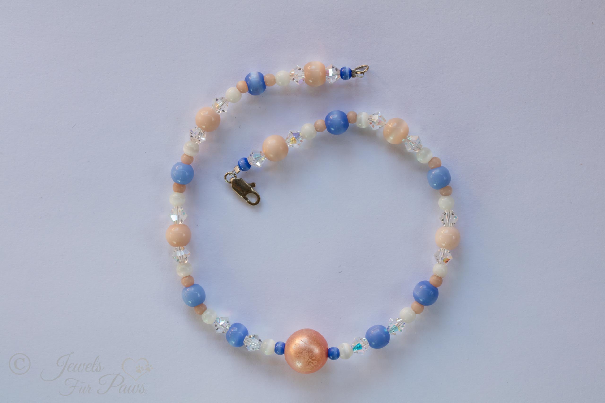 cat dog pet necklace large salmon orange bead with cats eye blue and white beads on white background