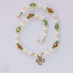 dog cat pet necklace green, white and amber beads with silver hanging lucky shamrock four leaf clover charm on white background