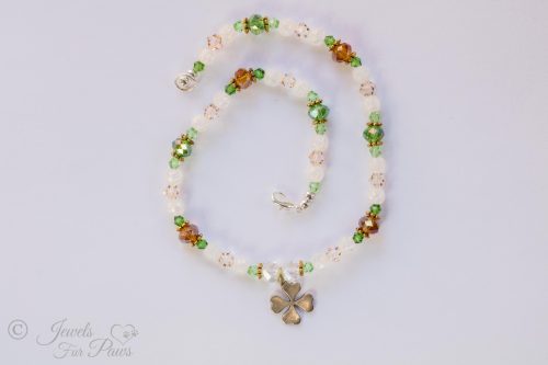 dog cat pet necklace green, white and amber beads with silver hanging lucky shamrock four leaf clover charm on white background