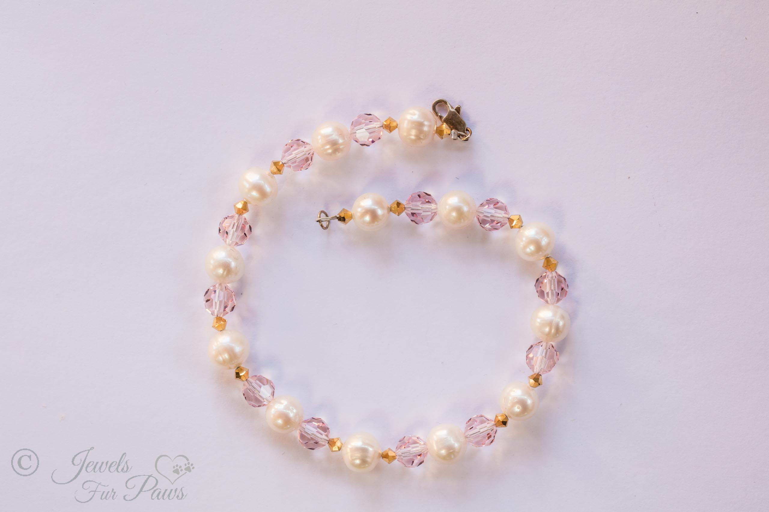 thirteen cultured pearls strung with pale pink Czech crystals and amber crystal spacers