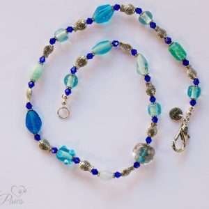 cat dog pet necklace with large blue crystals and large marbleized bead with silver fish spacers on white background