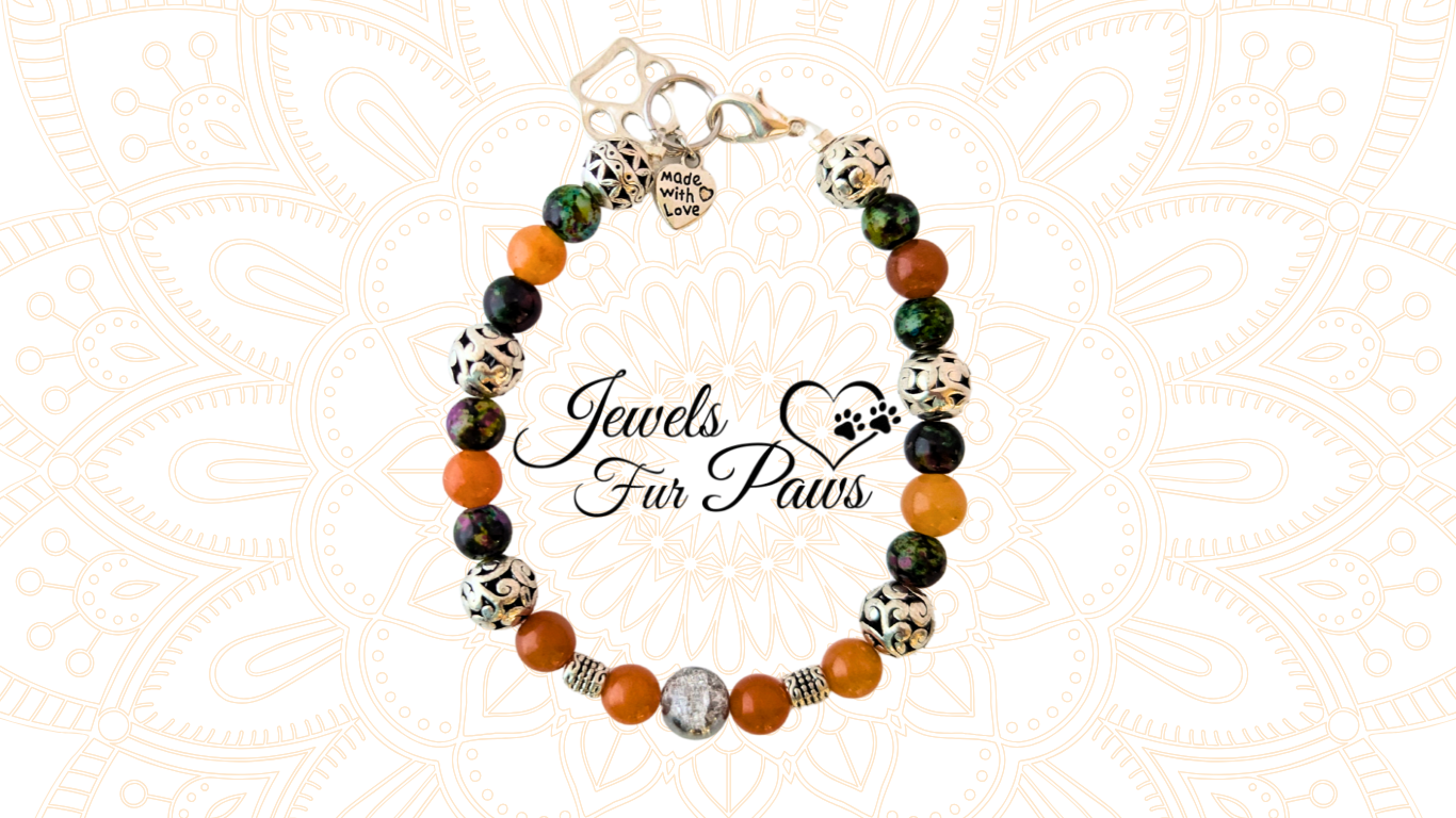 Handcrafted Pet Sacral Chakra Necklace featuring orange calcite crystals, silver spacers, and a heart and paws charm. Designed to promote emotional balance, grounding, and healing for pets